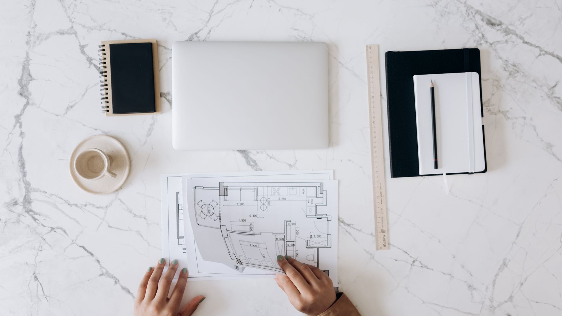 Architect's work table with blueprints, laptop, and drafting tools