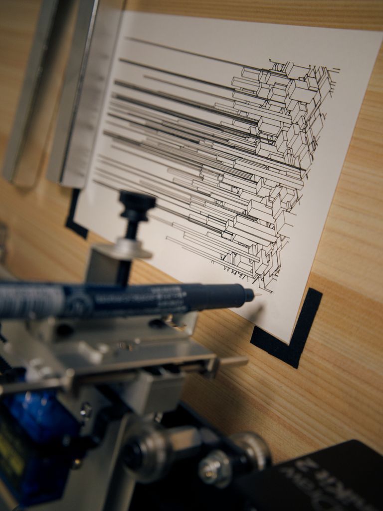 Close-up view of generative line art on paper using a mechanical plotter, showcasing industrial precision.