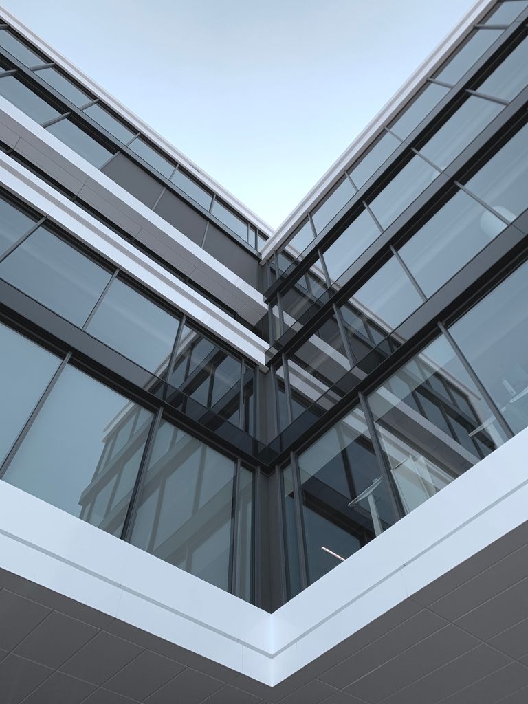 A sharp architectural angle of a modern office building with glass windows in Amsterdam.