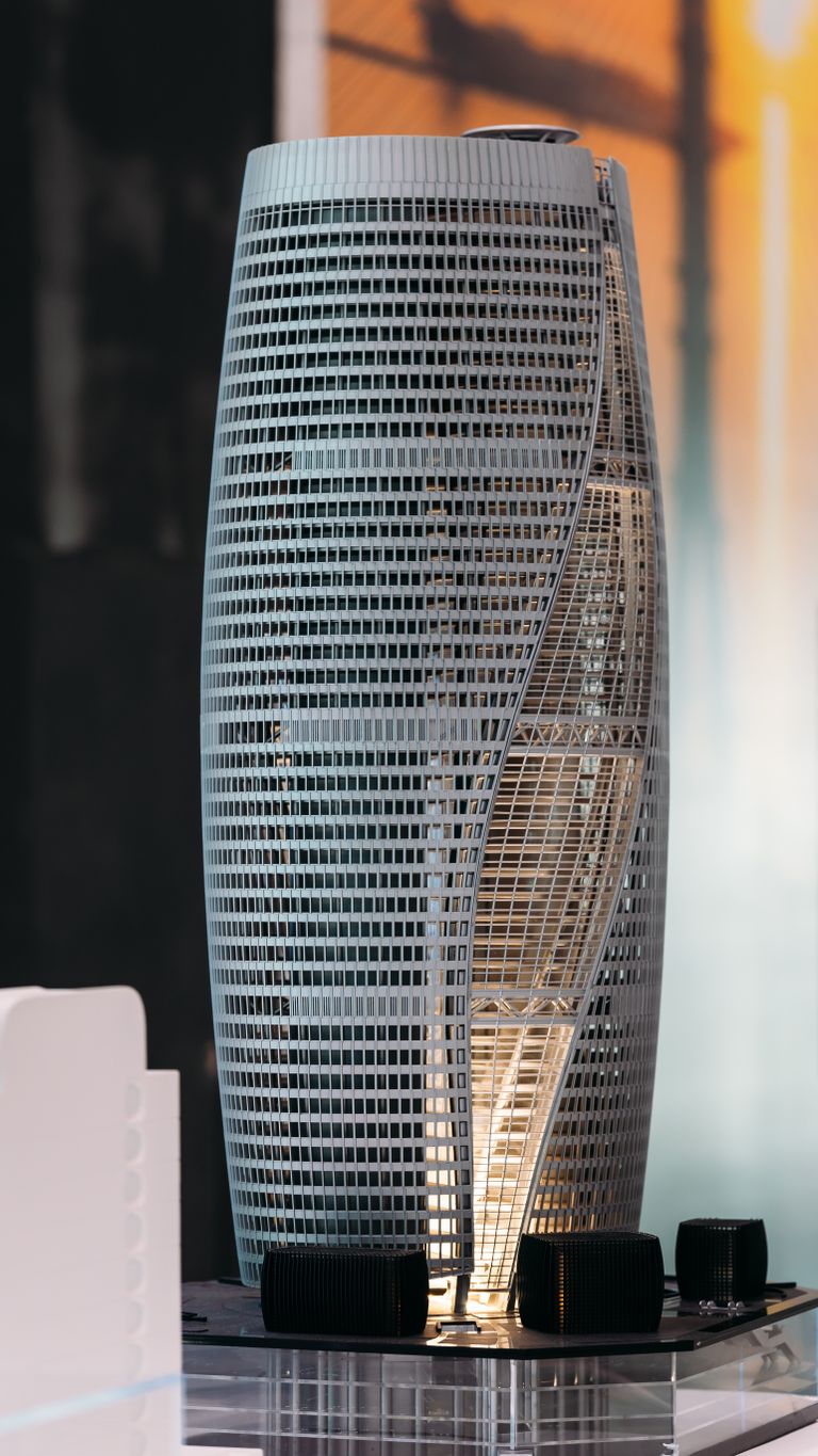 Intricate architectural model of a twisting skyscraper with modern design features.